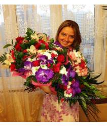 Девушка держит в руках четыре сборных букета